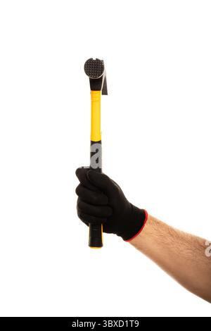 Man's hand in construction glove holding yellow hammer isolated on white background. Stock Photo