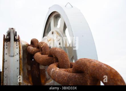 Ship rusty anchor chain on a winch. Stock Photo