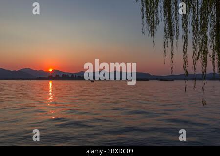 Red and orange sunset over West Lake in Hangzhou, China Stock Photo