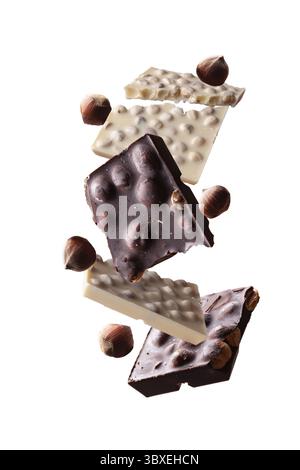 Pieces of dark and white chocolate with hazelnuts swirl on a white background Stock Photo