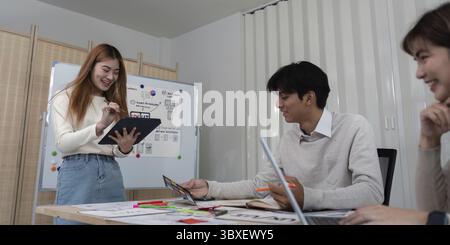 Ux developer and ui designer presenting mobile app interface design on whiteboard in meeting at office. Creative digital development mobile app agency Stock Photo