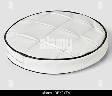 White round leather seat cushion pad with black piping detail, isolated on white Stock Photo