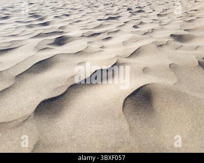 Close-up of desert sand wave formations with sharp and blurred textures Stock Photo