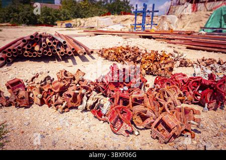 View on heap of disassembled steel scaffolding joint on construction site Stock Photo