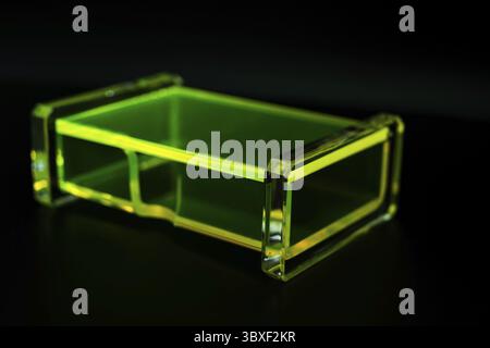 Abstract green transparent plastic box dark background Stock Photo