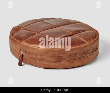 Brown round leather cushion with visible stitching and zipper closure, isolated on white background Stock Photo
