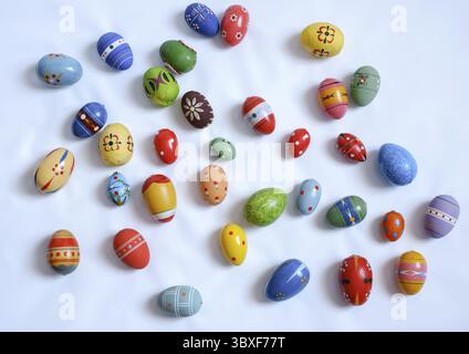 Multicolored wooden eggs on white background Stock Photo