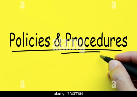 Policies and Procedures hand written text on yellow notepad Stock Photo
