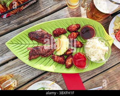 Beef steak with chicken wings and white cabbage salad, top view Stock Photo