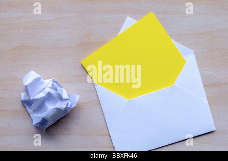 Top view of empty yellow notepad inside an envelope with customizable space for text Stock Photo