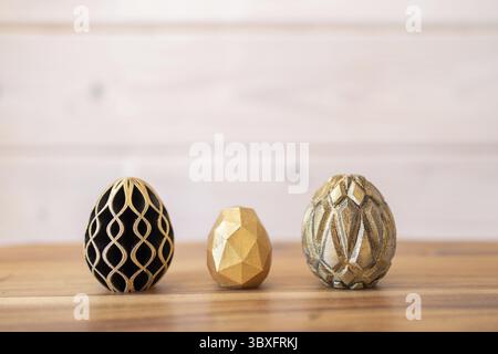 Trendy Easter low poly decor. Golden and black eggs of geometric style. Happy Easter greeting card. Holiday concept in minimal style Stock Photo