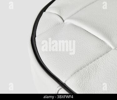 Close-up of white leather upholstery highlighting the detailed stitching and black piping Stock Photo