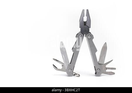 Close up of opened metal multitool with pliers knife screwdriver and can opener isolated on white background Stock Photo