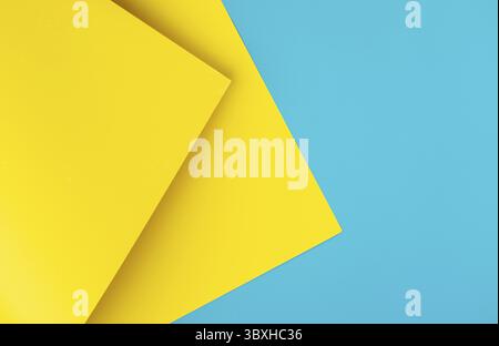 Yellow and blue colored background of overlapped cardboard layered geometric shaped sheets. Abstract design concept. Surface elements. Shredded textur Stock Photo