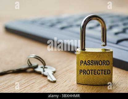 Password protected text engraved on padlock with keyboard background. Password security concept Stock Photo
