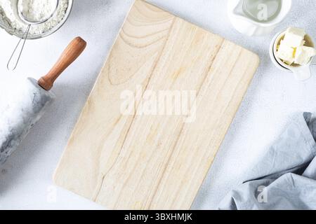 Food, The concept of homemade baking is a marble rolling pin, flour, butter, milk on a white background. Copy space. Top view. Baking concept Stock Photo