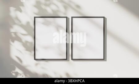 Blank black vertical frames mock up with leaves shadows and sunlight on white wall background, 3d rendering Stock Photo