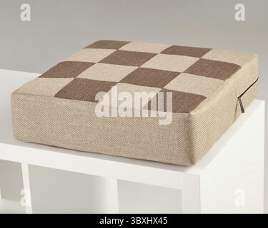 Comfortable checkered seat cushion in brown and beige tones provides a cozy and stylish seating solution Stock Photo