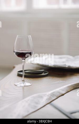 Glass of red wine on gray blurred background. Stock Photo