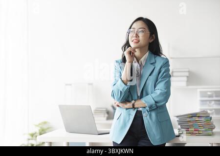 Portrait of young Asian business woman in modern office Stock Photo