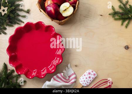 Food, Red fresh apples and a ceramic mold for making homemade apple pie for Christmas and New Year. Copy space Stock Photo