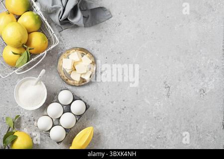 Food, Ingredients for making a pie with lemon curd and blueberries on a white stone table Stock Photo