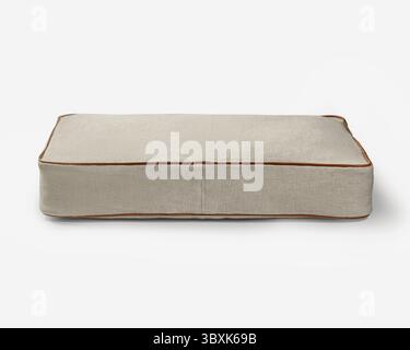 Rectangular light brown pet bed with brown leather piping on white background, perfect for a comfortable and stylish resting spot for furry friends Stock Photo