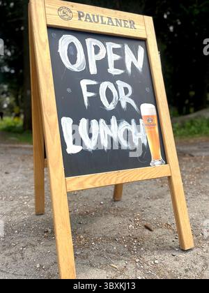 Chalkboard sidewalk sign outside a restaurant with handwritten "Open for Lunch" message, inviting customers in, Vitosha Mountain, Eastern Europe, EU Stock Photo