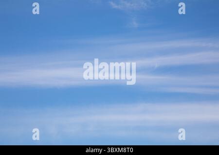 blue sky with a small amount of thin white wispy clouds Stock Photo