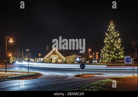 Light trails on the roundabout with Christmas decorations Stock Photo