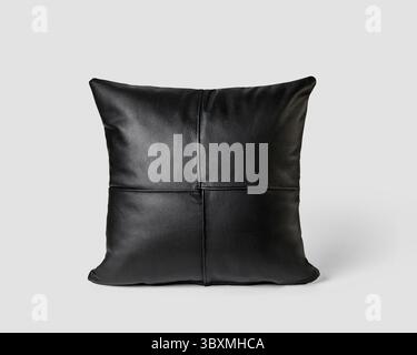Elegant couch cushion featuring made of neatly stitched patches of smooth black leather isolated on white background. Handcrafted interior design item Stock Photo