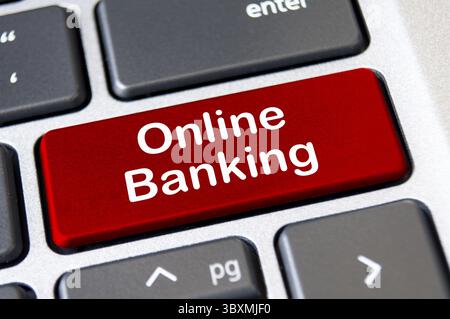 Online banking text on red laptop keyboard button. Banking and transaction in digital form concept Stock Photo