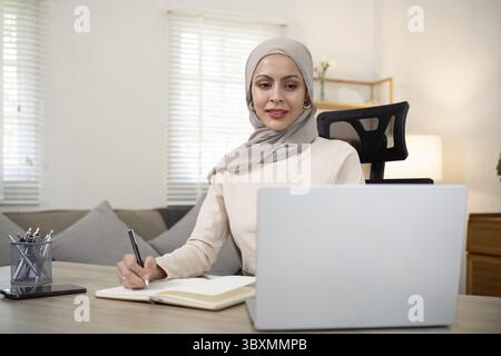 Portrait asian muslim woman manager working with laptop computer at home Stock Photo