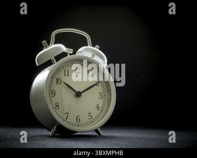 White retro alarm clocks on black background Stock Photo