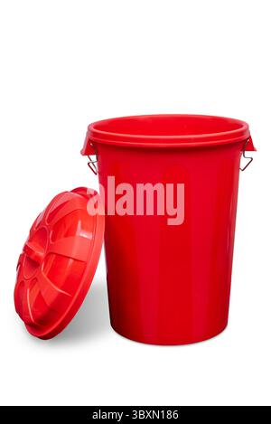 Open red plastic trash bin can with lid resting on the side isolated on white with clipping path included Stock Photo