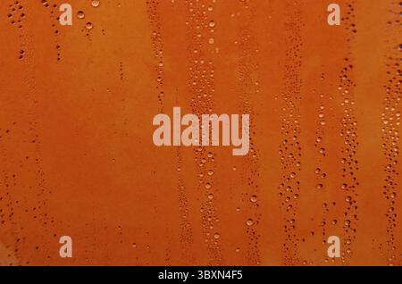 Rain droplets on orange color background suitable for wallpaper decoration or design Stock Photo