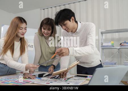 A diverse team of UX developers and UI designers collaborating and brainstorming on new project ideas in a modern office setting Stock Photo