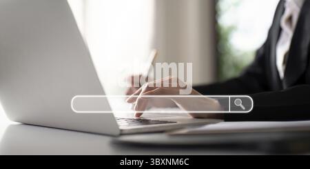 Search technology, search engine optimization, businesswoman using laptop to search information, using search bar function on your website Stock Photo