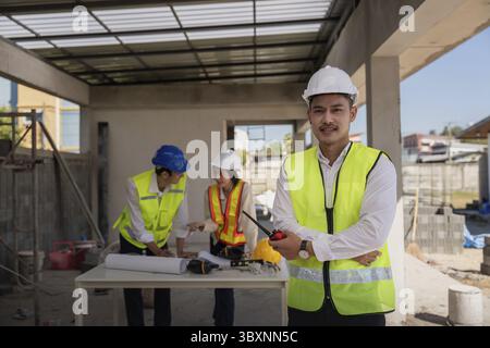 Happy of team construction worker. engineer, construction site and team outdoor for building project Stock Photo