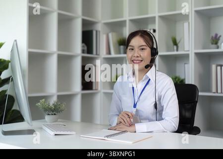 Call center woman asian in office for customer service, technical support and advice, contact and communication with employee operator in help desk ag Stock Photo