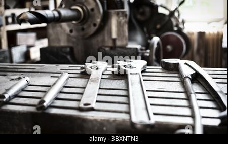 Vintage old metallic tools laying on a iron table surface Stock Photo