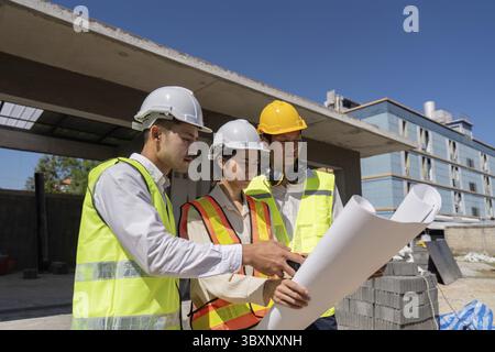 Construction of engineer or architect meeting for project working with partner and engineering tools on building and blueprint in working site Stock Photo
