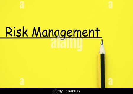 Risk management text written on yellow paper background Stock Photo