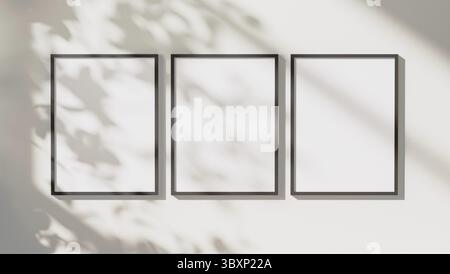 Empty black vertical rectangular frames mock up with leaves shadows and sunlight on white wall background, 3d rendering Stock Photo