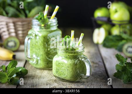 Food, Two healthy green smoothie with spinach, banana, apple, kiwi and mint in glass jar Stock Photo