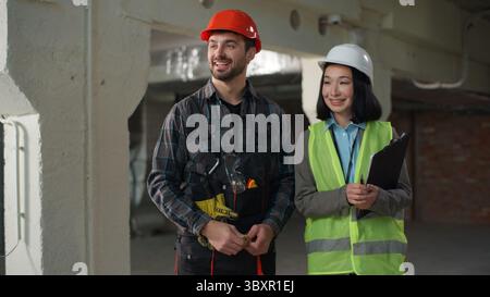 Business builders handshake Japanese Caucasian engineers shaking hands partnership colleagues workers woman man discussing build project agreement Stock Photo