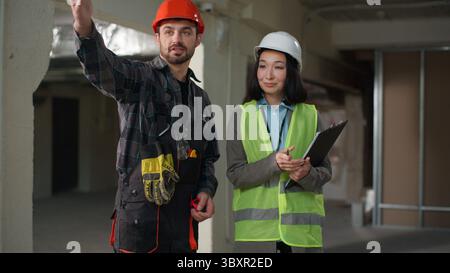 Business builders handshake Japanese Caucasian engineers shaking hands partnership colleagues workers woman man discussing build project agreement Stock Photo