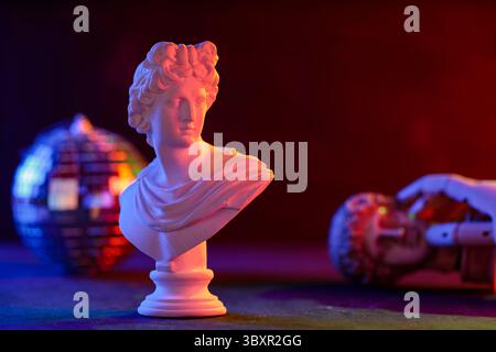 Classical Sculpture Bust Cradled in Mannequin Hand Neon Disco Ball Stock Photo