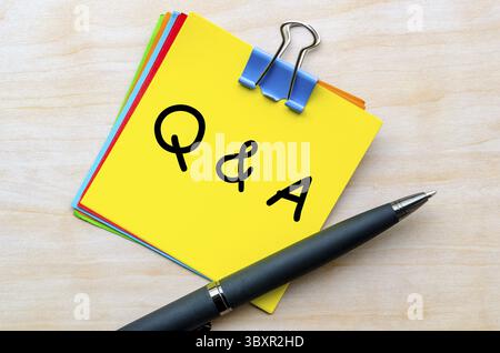 Q and A text on yellow notepad. Question and Answer concept Stock Photo