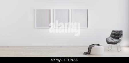 Three blank poster frames in room with white wall and wooden floor with white pouf and grey modern armchair. Bright room interior with empty frames mo Stock Photo